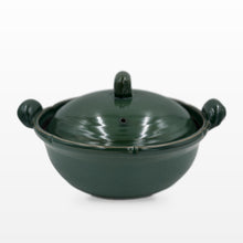 A dark green glazed ceramic lidded casserole or stockpot with side handles, photographed on a clean white background.